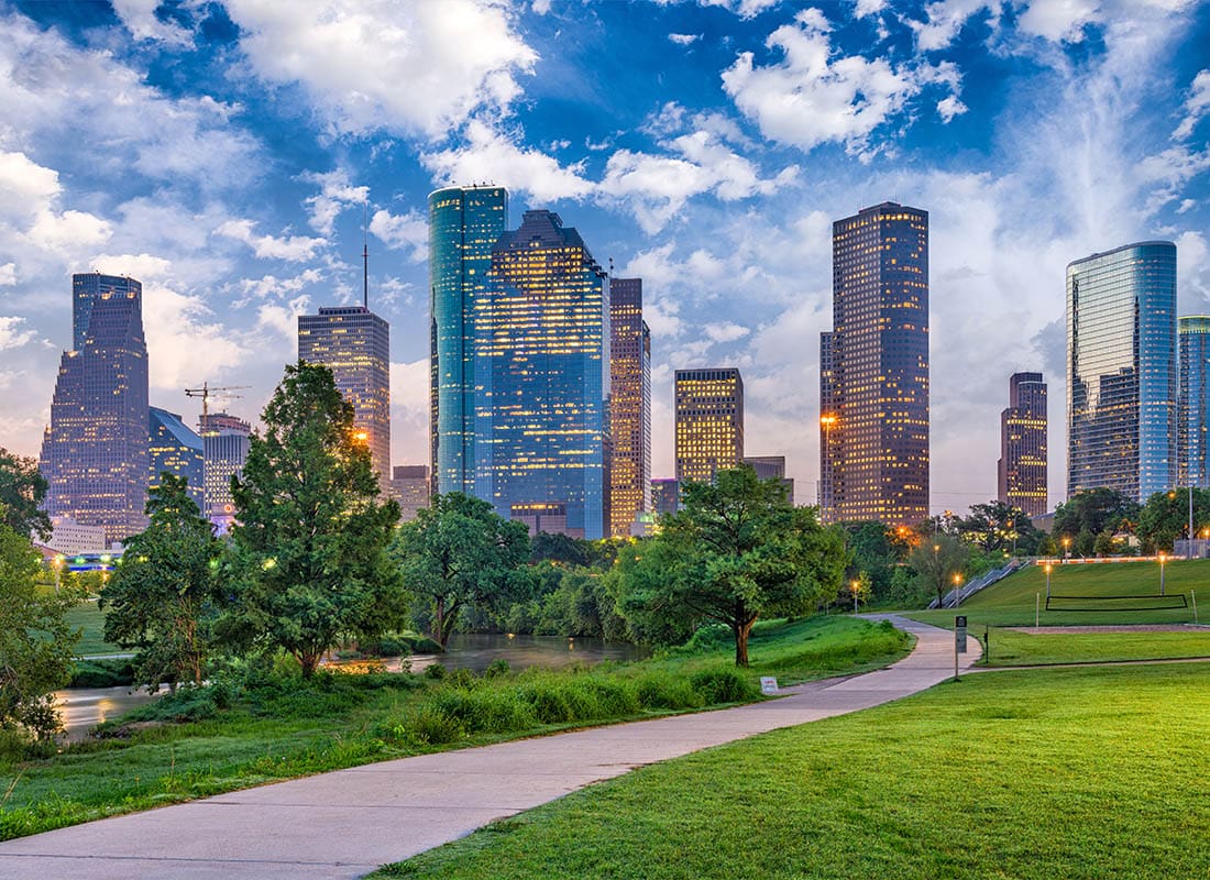 Contact - Beautiful View of a Park With a Walkway in the Middle in Houston, Texas With Lit Up Skyscrapers